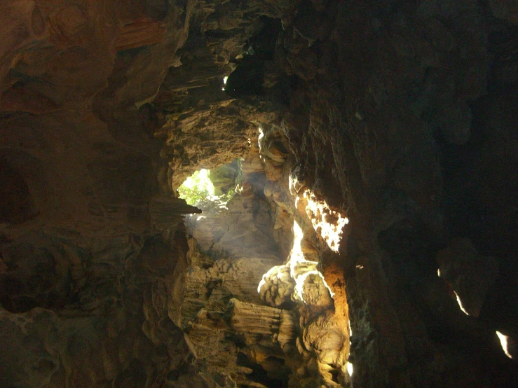 a light is shining through a cave in the middle of nowhere