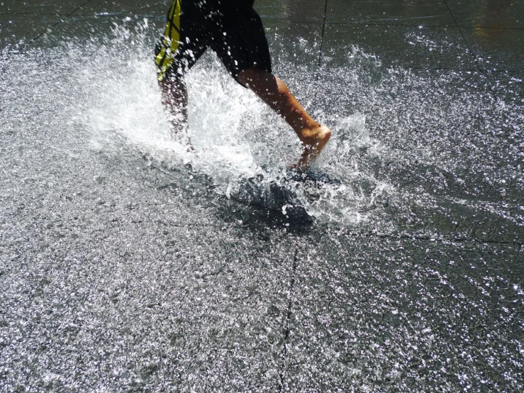 a man riding skis in the water next to his foot