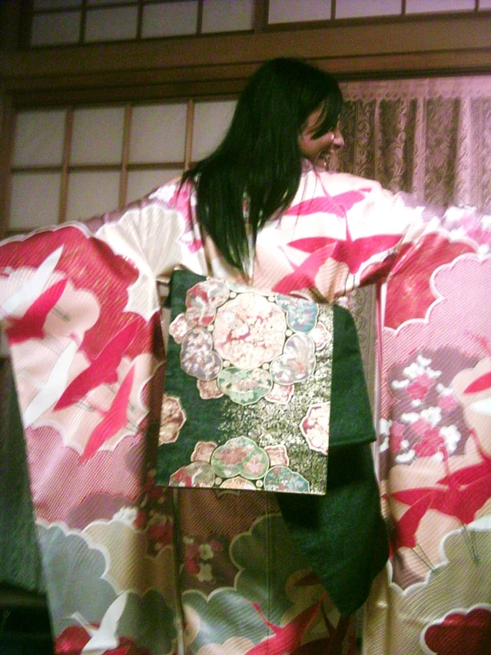 an asian lady is carrying a kimono