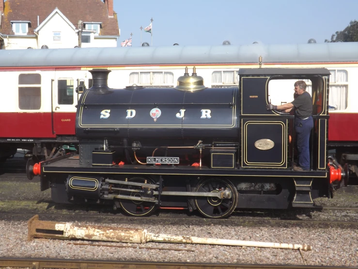 a train conductor in an old fashioned style steam engine