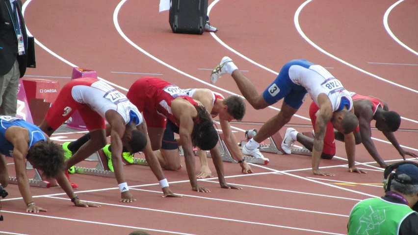 four men on the track doing different things