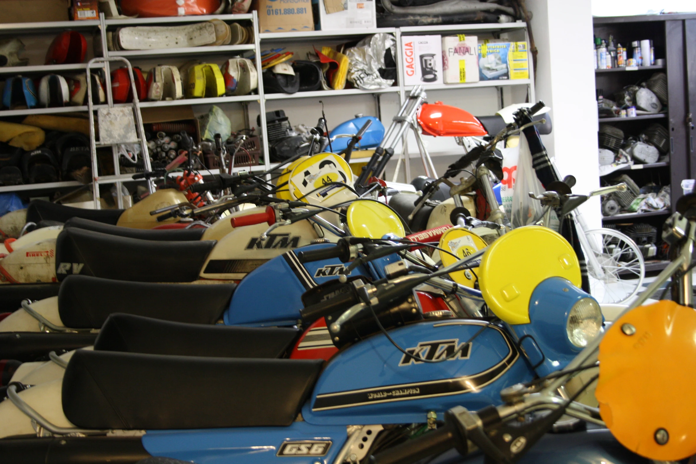 several different kind of motorcycles in a shop