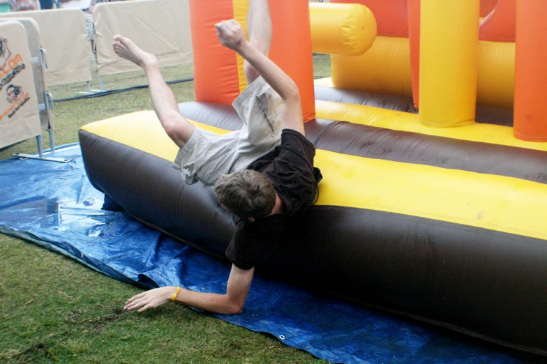 a boy sitting on top of an inflatable structure