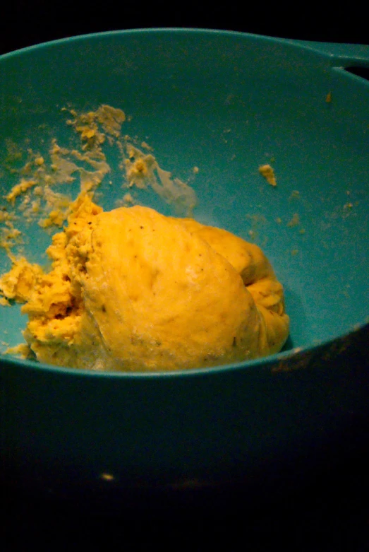 a mixing bowl filled with a mixture of yellow batter