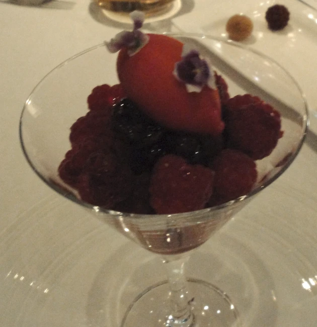 there is a dessert in a wine glass on a table