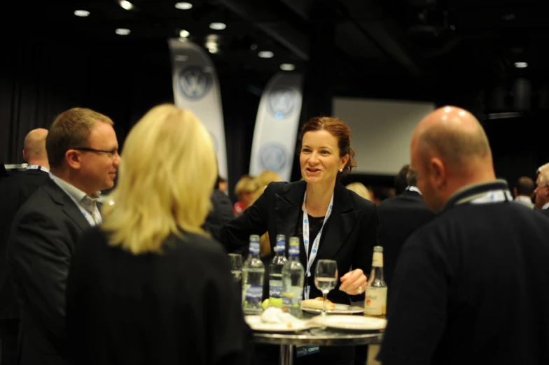 a woman is holding her hands out at the table