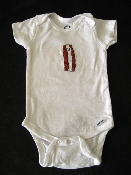a baby t - shirt with a small image on it