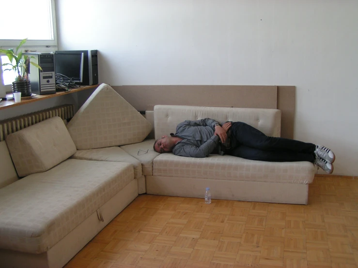 the woman is sleeping on the couch by himself