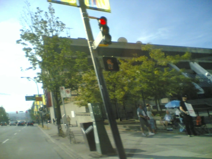 some people are standing outside near a sign