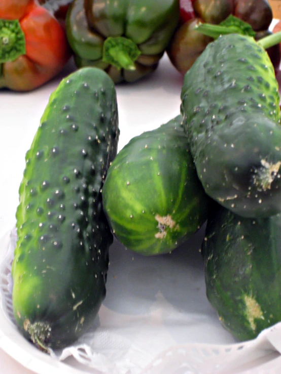 a pile of cucumbers sitting on top of a white plate