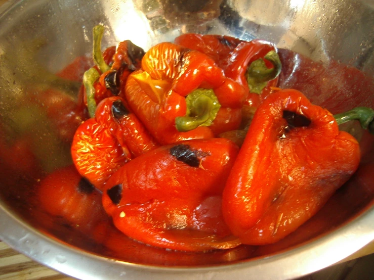 some roasted peppers and other vegetables are in the pan