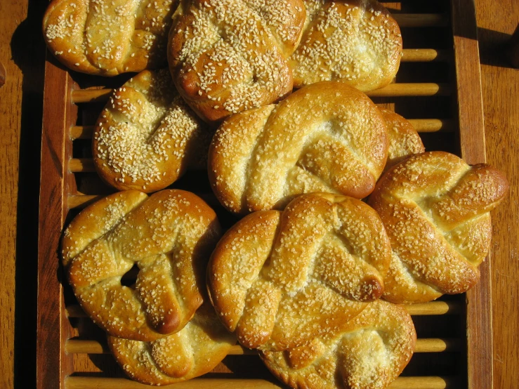 a group of donuts sitting on a wooden rack