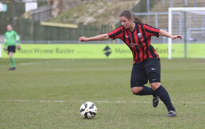 female soccer player dribbles the ball during a game