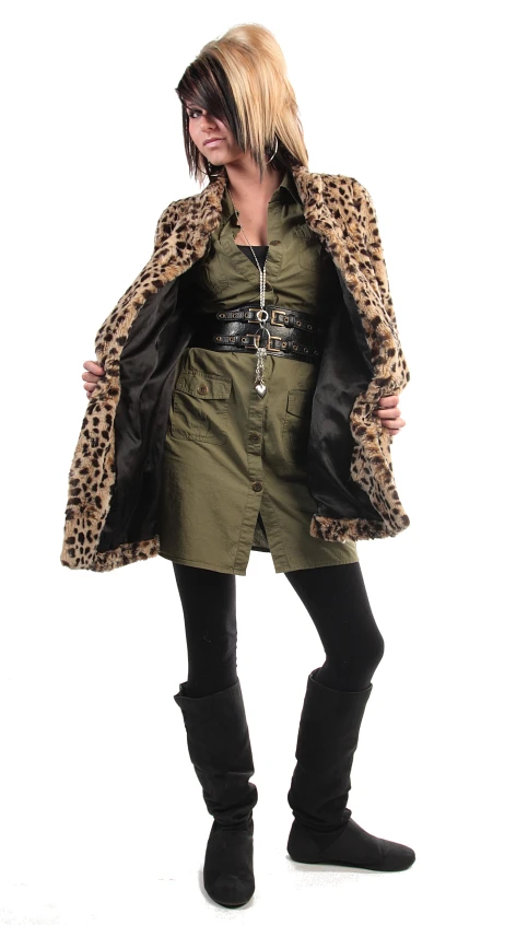 a woman wearing a green dress, leopard print jacket and thigh - high boots