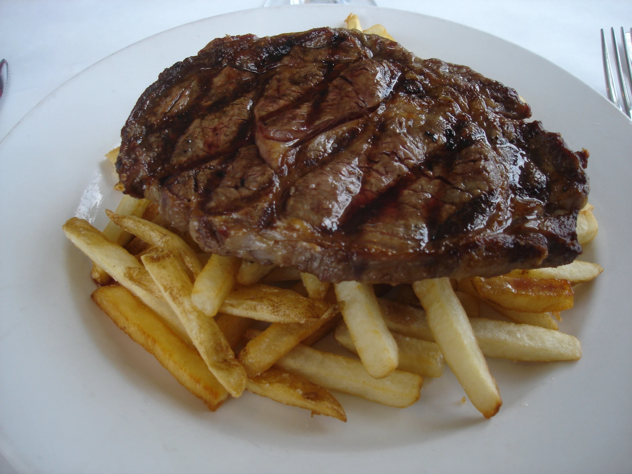 the steak and fries are sitting on a plate