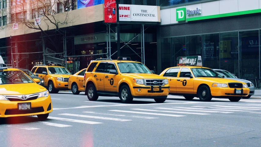 taxi cabs are traveling down the busy city street