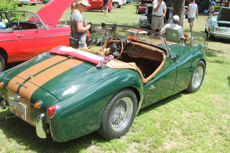 old cars parked on the grass at a classic car show