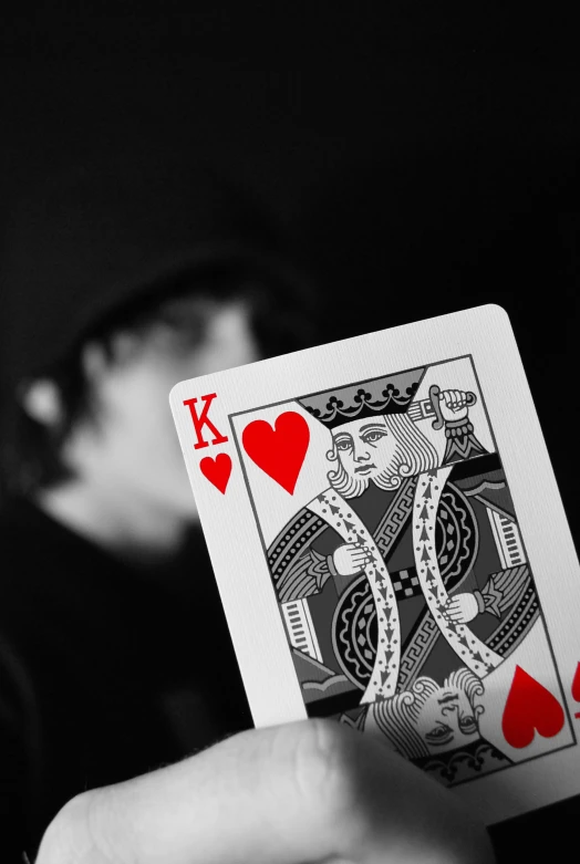 a person holding a playing card in their hand