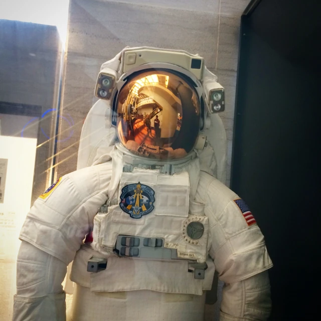 a astronaut wearing a white spacesuit that is outside of the building