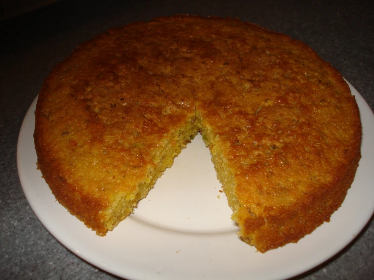 a cake is on a plate that has one slice removed from it