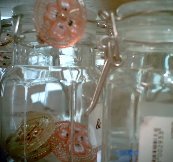 a close up of glass jars filled with various things