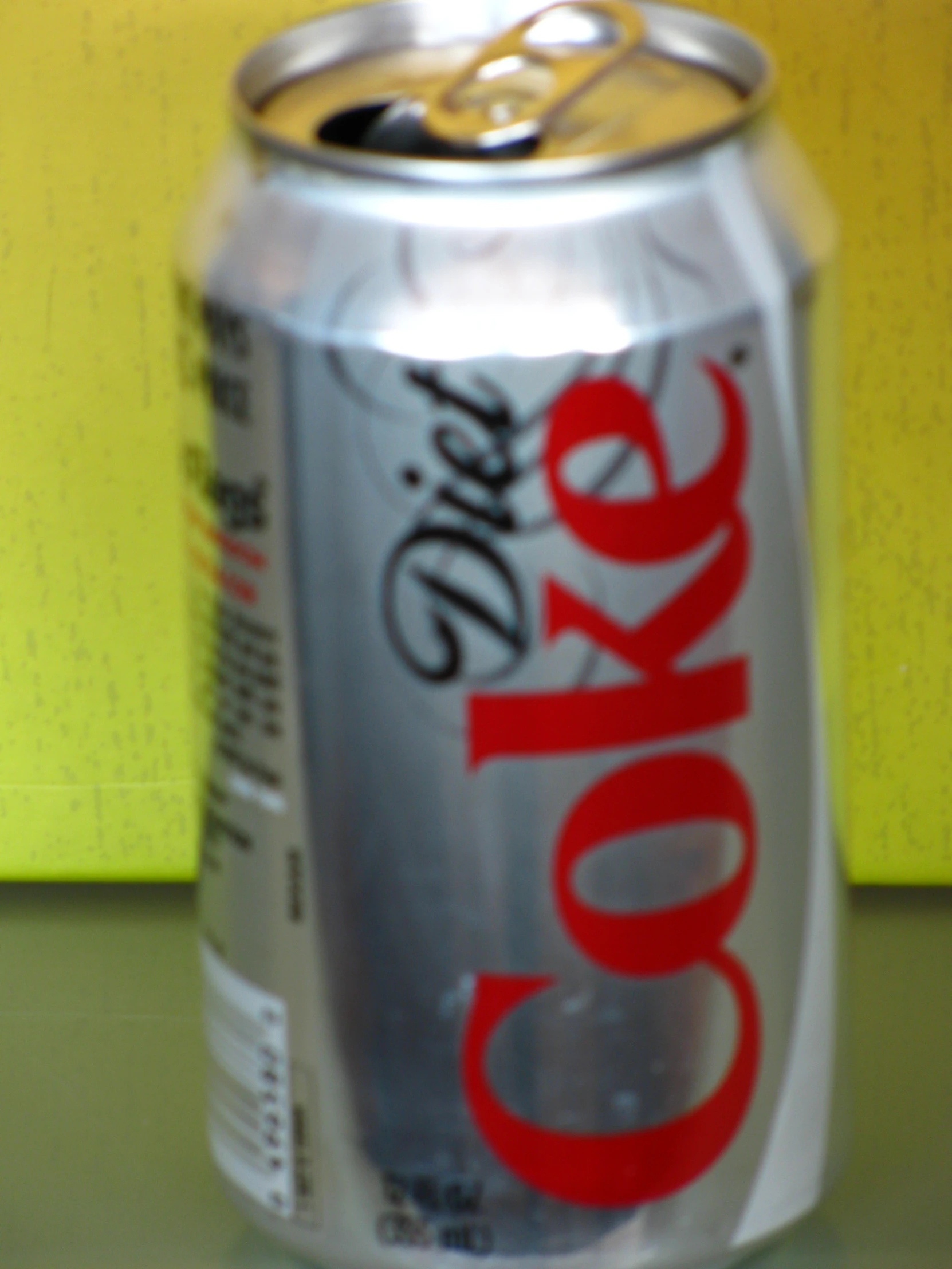 the can of coke has a bright red lettering