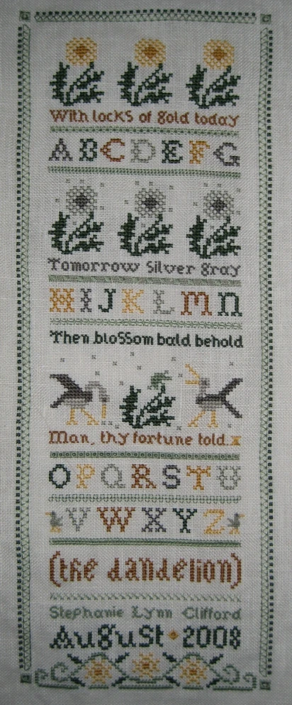 a sample of the first sample cross stitched to a linen sample