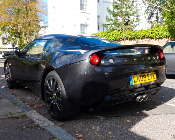 black sports car parked in a parking lot