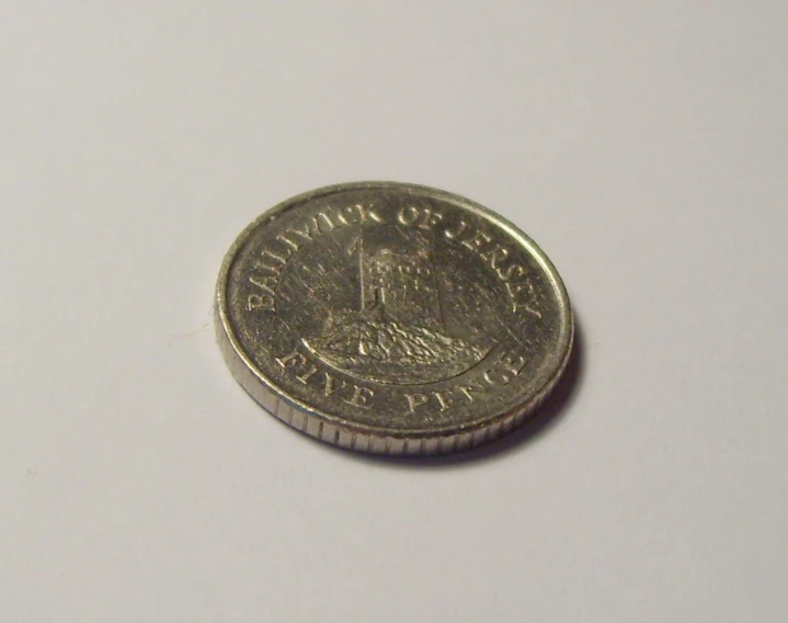 a close up view of a penny on a white surface