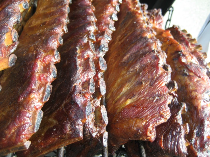 cooked ribs on a charcoal wire grill outdoors