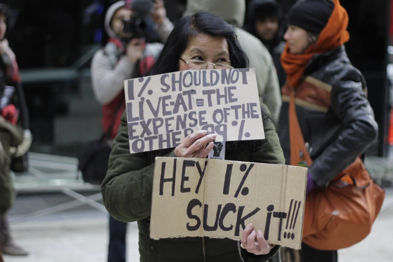 a woman holding a sign in front of her