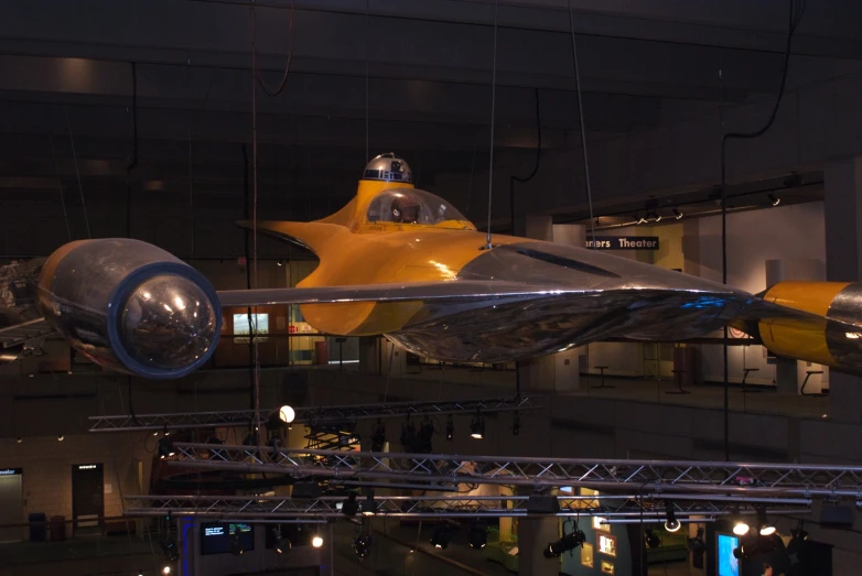 a model of a fighter jet suspended in a hanger