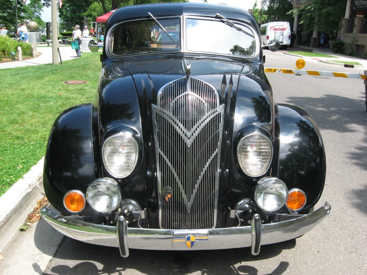 a classic car is parked along the curb