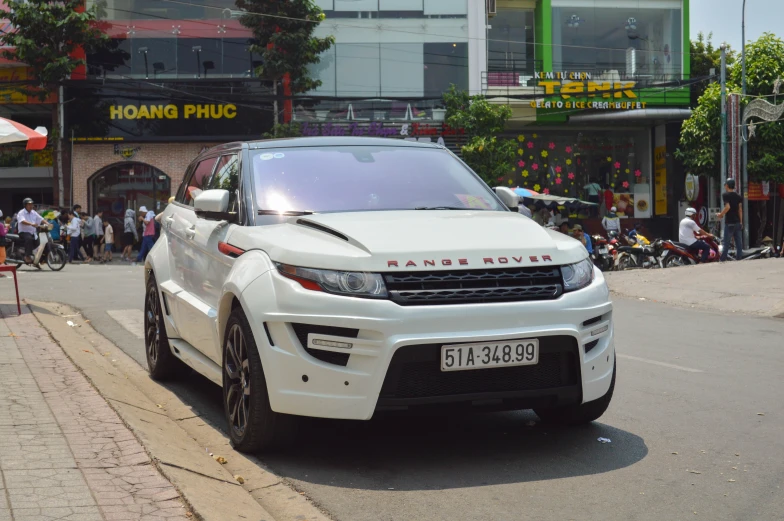 a white range rover sports utility vehicle in traffic