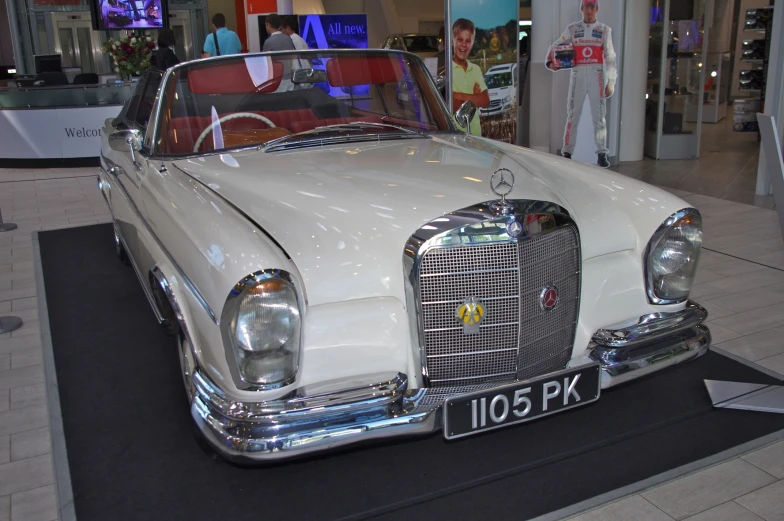 a car displayed at an indoor showroom in a shopping mall