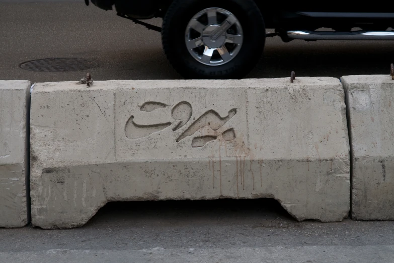 a cement block with graffiti reading 24x on it