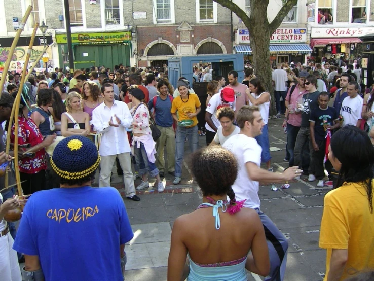 people gather around an intersection in the city