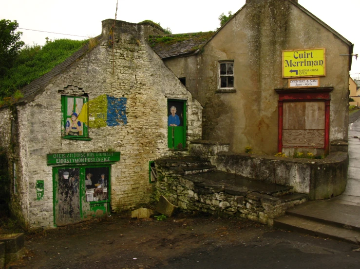 a large stone building has a green door and several windows