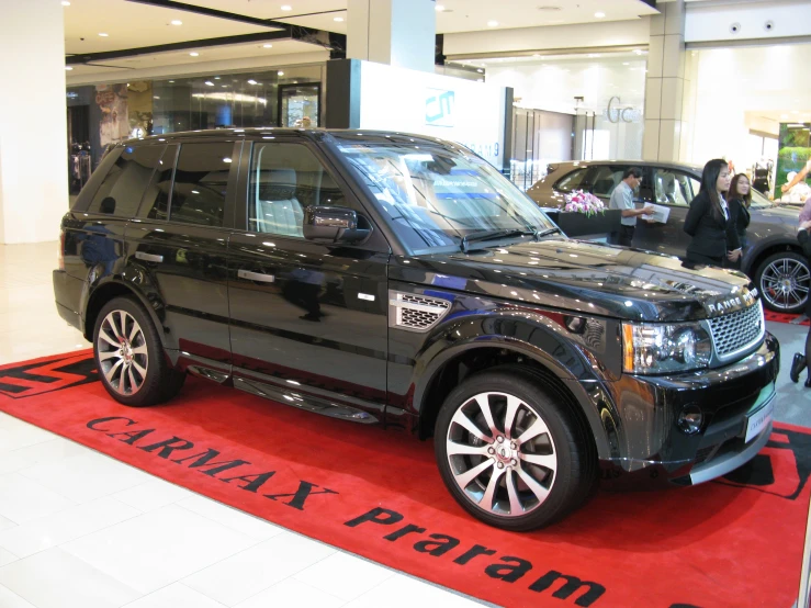 a land rover range is on display inside of a building