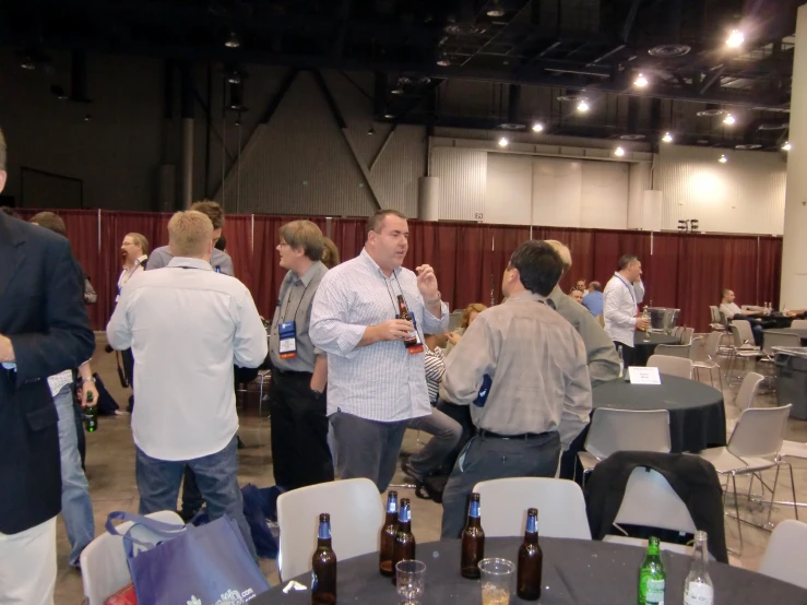 a group of people standing and sitting at tables