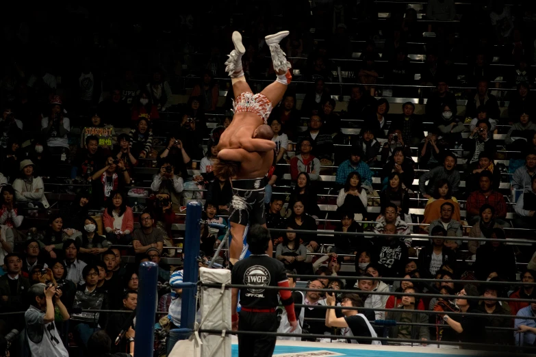 a man in an arena doing tricks on a rope