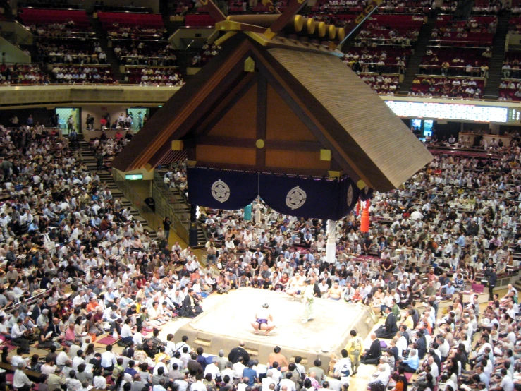 a group of people sitting on top of a wooden floor