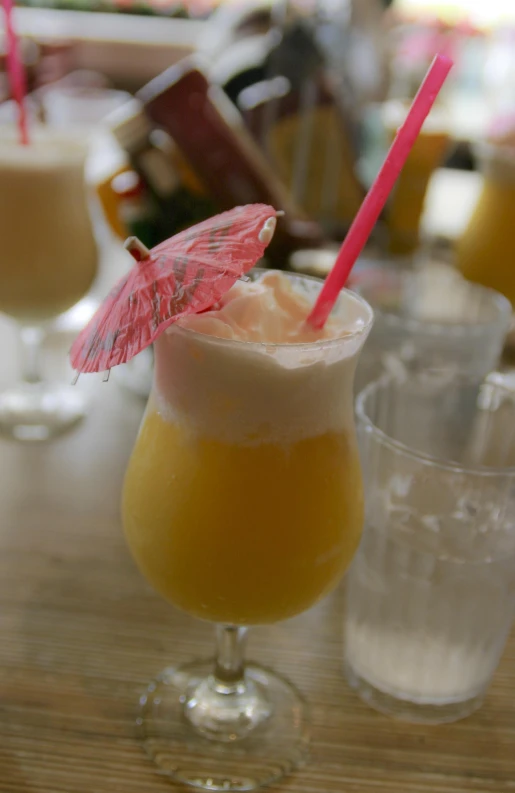 drinks with umbrella on top sit on a table