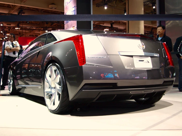 a silver car is parked inside a show room