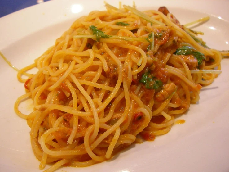 a plate of pasta with sauce and vegetables