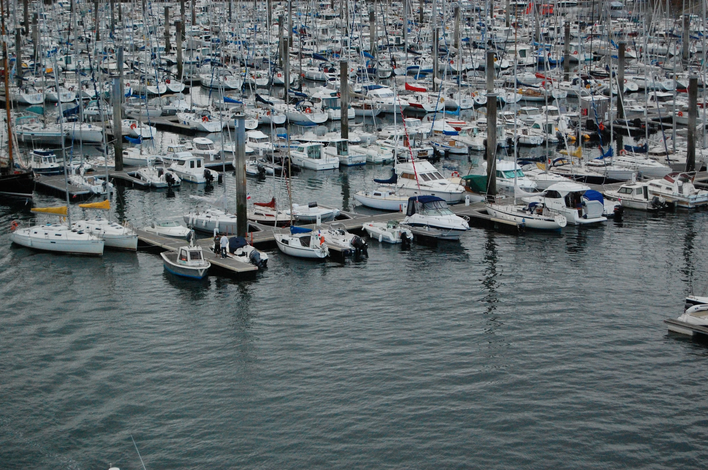 many small boats floating in a large body of water