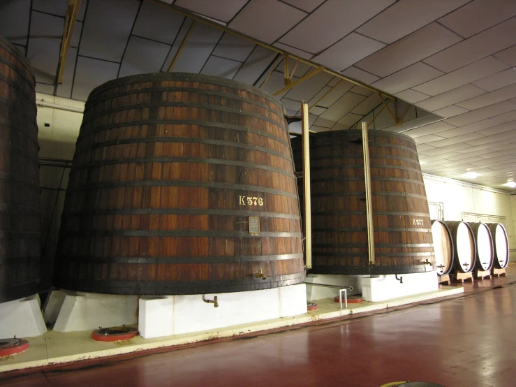 a few wooden barrels sit stacked up next to each other