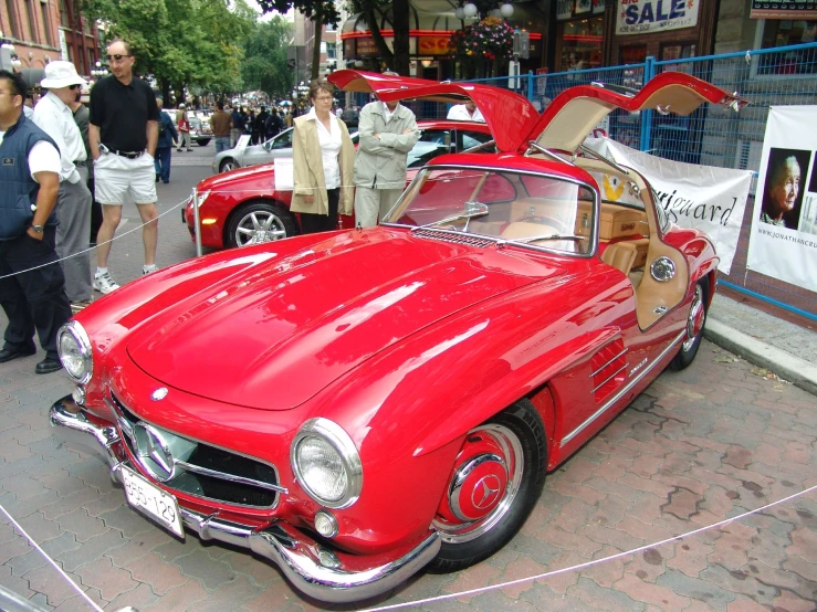 a classic car that has been sold on the sidewalk