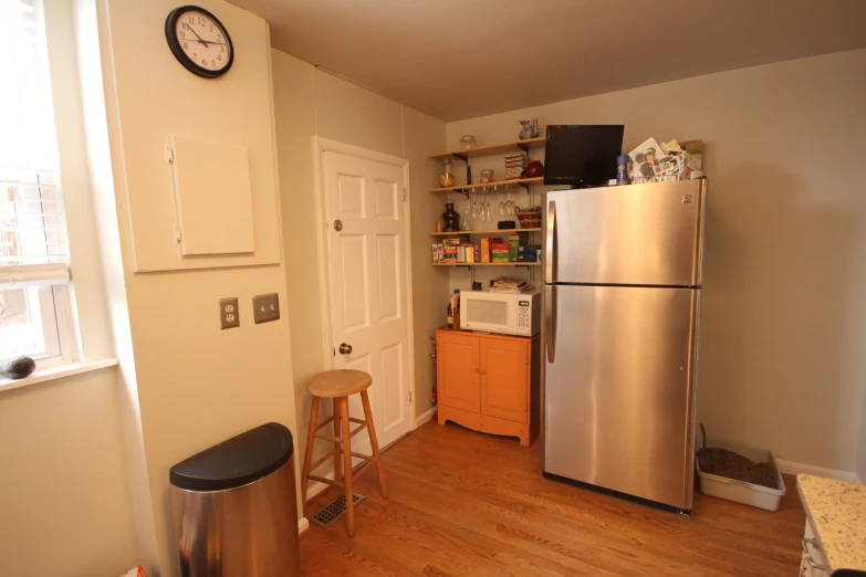 a refrigerator sitting next to a window and door