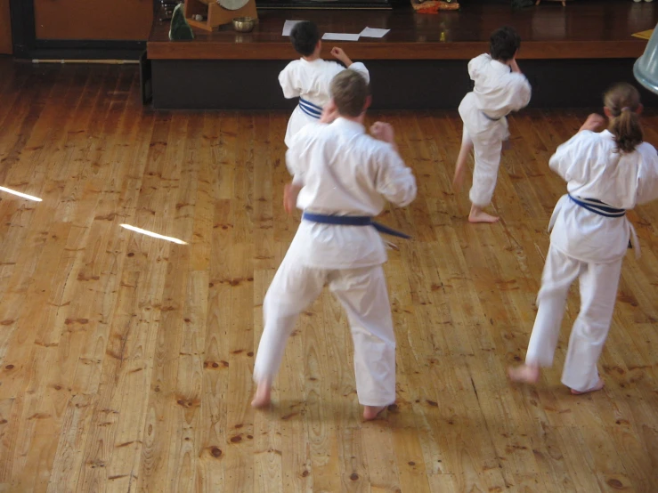 young s practicing karate in a gymnasium